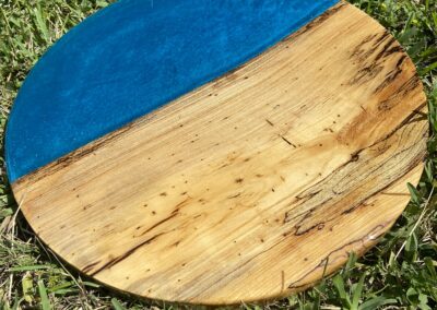 handmade 18" round tabletop made with spalted sweet gum and blue epoxy resin