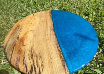 handmade 18" round tabletop made with spalted sweet gum and blue epoxy resin