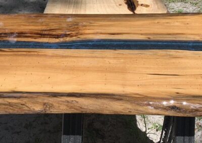 coffee table top made with spalted magnolia wood and blue epoxy resin.